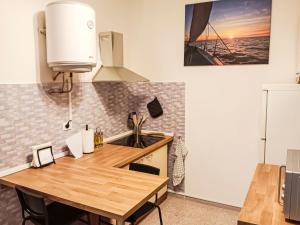 a kitchen with a wooden table and a sink at Al convento rustico in Trieste