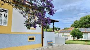 Una casa con flores púrpuras a un lado. en Casa do Paço Aveiro Studio&Rooms, en Aveiro