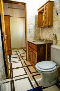 a bathroom with a toilet and a tiled floor at Cabañas Dorys Cataratas Del Iguazu in Puerto Iguazú +58 photos