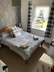a bedroom with a bed with two towels on it at Bella Vista in Paignton