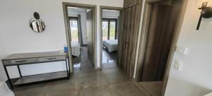 a room with a bed and a table and a mirror at Theasis 2 in Neos Marmaras +60 photos
