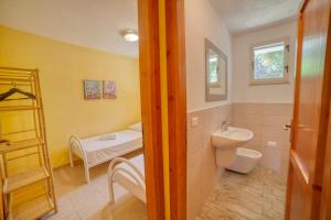 a bathroom with a white toilet and a sink at Casa Vacanza Sole & Luna in Stintino