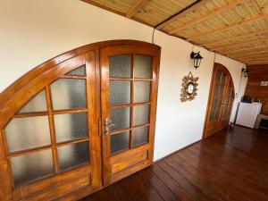 a large wooden door in a room with wooden floors at Casa Ilinca in Filioara