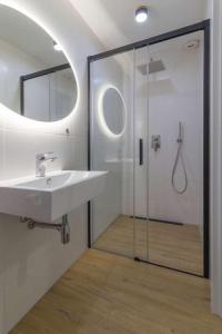 a bathroom with a sink and a glass shower at Villa Viola in Mielno