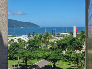 a view of the ocean from a building with trees at Pé na Areia in Santos