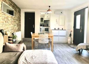 a living room with a table and a kitchen at Chambre privée chez l'habitant dans duplex alsacien in Erstein