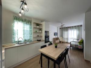 a kitchen and dining room with a wooden table and chairs at Casa Melina in Arona