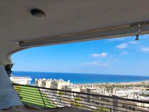 a balcony with a view of the ocean and buildings at Infinity View by Mar Holidays - Arenales del Sol in Arenales del Sol