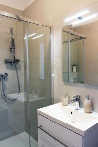 a bathroom with a sink and a glass shower at Apartment Limoni in Sutivan