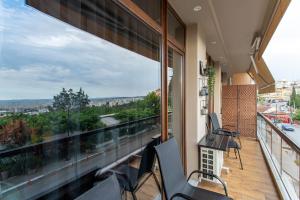 a balcony with chairs and a view of the city at Old town view apartment in Thessaloniki