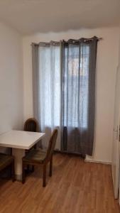 a room with a table and chairs and a window at Premier Double room MZ in Vienna