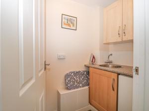 a small kitchen with a sink and a counter at The Annexe in Petworth
