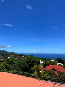 a view of the ocean from the roof of a house at Habitation La Reine du Camp Chambres d'Hôtes in Saint-Claude