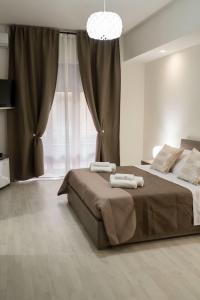 a bedroom with a bed with two towels on it at B&BSCICCHERI in Castellammare di Stabia