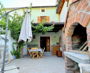 a patio with a table and an umbrella at Casa Bella Holiday Home Rab in Rab