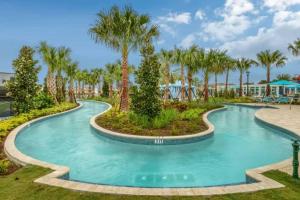 a pool at a resort with palm trees at Luxury 5BD/5BH Home With Pool/BBQ Disney Universal in Kissimmee