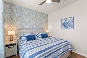 a bedroom with a bed with blue pillows at Luxury 5BD/5BH Home With Pool/BBQ Disney Universal in Kissimmee