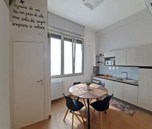 a kitchen with a table and chairs in a room at REGINA ANNA HOME in Bari
