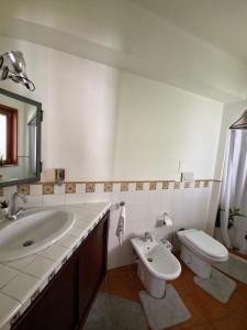 a bathroom with a sink and a toilet at Tok Tok Taormina in Taormina