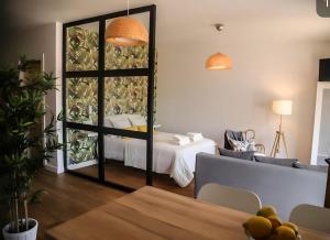 a living room with a bed and a table in a room at Apartamentos Dacosta in Ribadeo