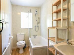 a bathroom with a toilet and a shower and a sink at 21 Mill Green in Lyme Regis +24 photos
