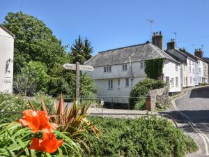 a street sign with an orange flower in a village at 21 Mill Green in Lyme Regis