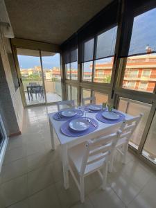 a dining room with a white table and chairs at Sweet home Salou in Salou +13 photos