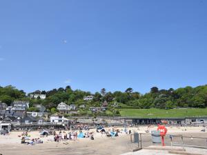 a group of people on a beach with houses at The Old Garage in Lyme Regis