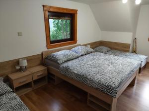 a bedroom with two beds and a window at Chata u Michala- neakceptujeme mladé partie in Terchová