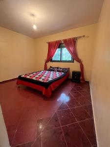 a bedroom with a bed in a room with a window at Maison calme et paisible in Beni Mellal