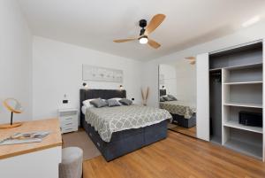 a bedroom with a bed and a ceiling fan at Casa Fiumana Laura in Rijeka