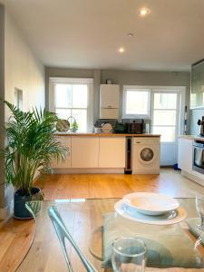 a kitchen with a table with a plate on it at Home in Chiswick Homefields in London