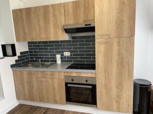 a kitchen with a sink and a stove at Merlimont-plage: studio in Merlimont
