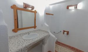 a bathroom with a sink and a mirror at Estação Santa Fé Hotel e Pousada in Arraial d'Ajuda