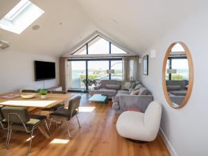 a living room with a table and chairs at Porth Cove in Newquay