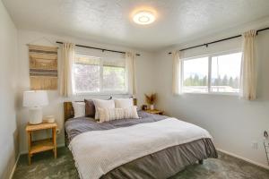a bedroom with a bed and a window at Spirit Lake Home with Fenced Yard 1 Mi to Water! in Spirit Lake