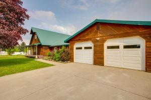 a garage with two white garage doors on a house at Spirit Lake Home with Fenced Yard 1 Mi to Water! in Spirit Lake