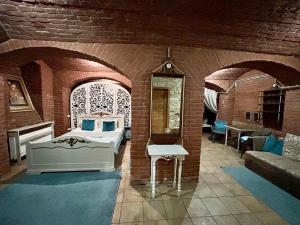 a bedroom with a bed in a brick wall at Budget Family Hotel in Lviv