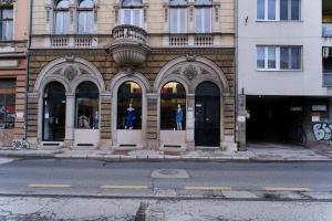 a building with arches on the side of a street at All seasons apartments Sarajevo with free parking in Sarajevo