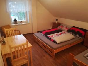 a room with a bed and a table and a dining room at Holiday home in Rokytnice n. J. 35171 in Rokytnice nad Jizerou