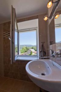a bathroom with a sink and a large window at Holiday home in Rokytnice n. J. 35171 in Rokytnice nad Jizerou