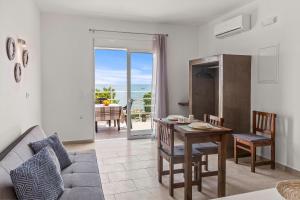 a living room with a table and a couch at Summer Paradise Stegna Rhodes in Archangelos
