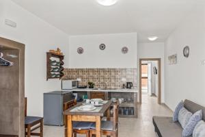 a kitchen and living room with a table and chairs at summer paradise stegna rhodes in Archangelos