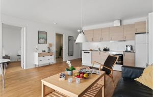 a living room and kitchen with a table and a couch at Awesome Apartment In Allinge With Wifi in Allinge