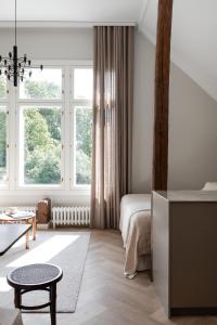 a bedroom with a bed and a large window at Villa Ryselin in Tampere