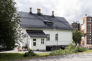 a white house with a black roof at Villa Ryselin in Tampere