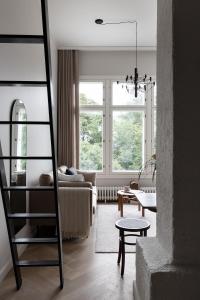 a living room with a ladder and a couch at Villa Ryselin in Tampere