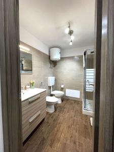a bathroom with a toilet and a sink and a tub at la casetta di Sophia in Torrenova +22 photos