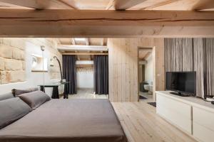 a bedroom with a large bed and a television at Garibaldi Luxury in Otranto