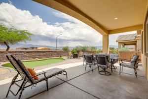 a patio with chairs and a table and a golf course at Mesquite Vacation Rental - Close to Golf Courses! in Mesquite